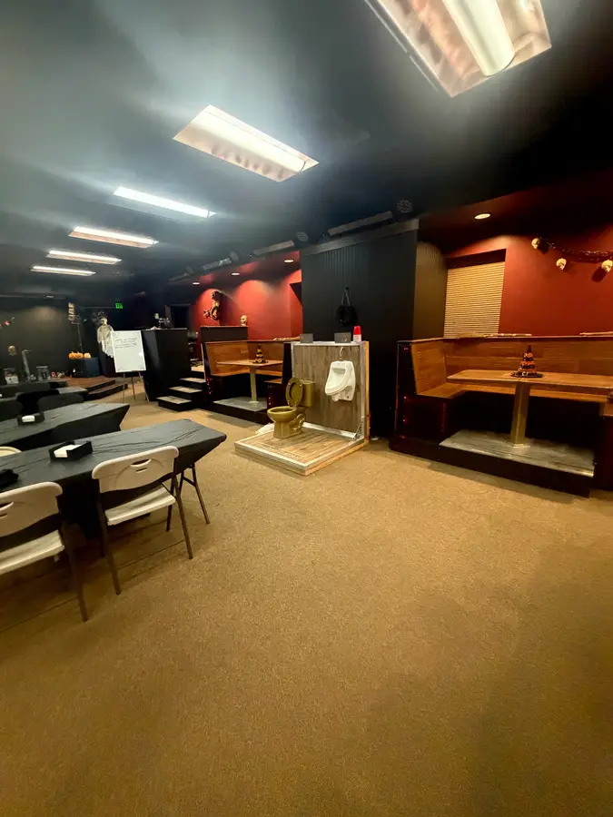 Event floor with banquet tables, booths and the stage